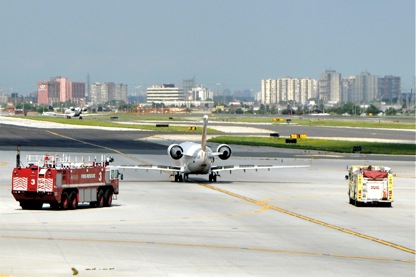 Jazz CRJ taxis in followed by fire trucks